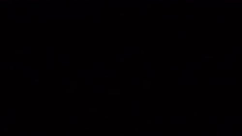 Christmas, Holidays And Illumination Concept - Close Up Of Electric Garland Lights In Dark Room