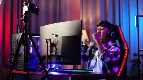 Asian Boy Streamer Celebrating Winning Game On Computer. Live Stream Video Game