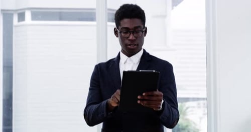 Professional Man Works on Tablet in Office Building