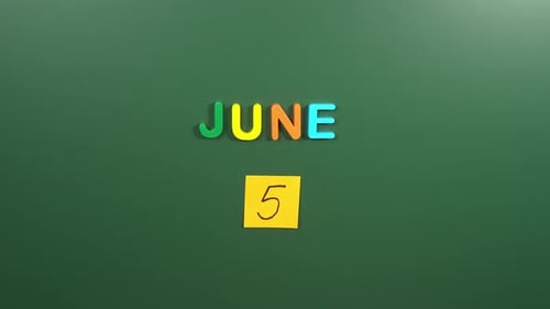 Hand sticking a sticker 5 June calendar day on school board. 5 date of June. Fifth day June