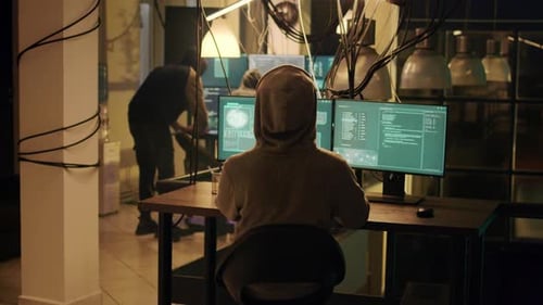 Hackers at Computer with Artificial Light