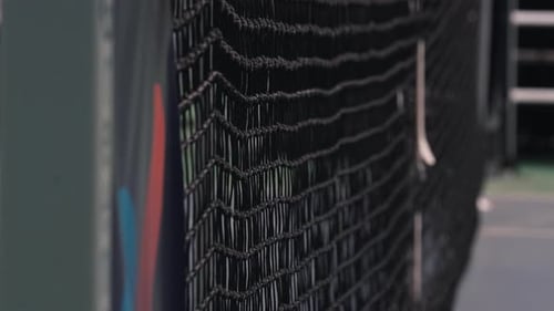Tennis net with blurred ball impact