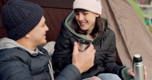 Smiling Couple Camping, Drinking Hot Beverage in Tent
