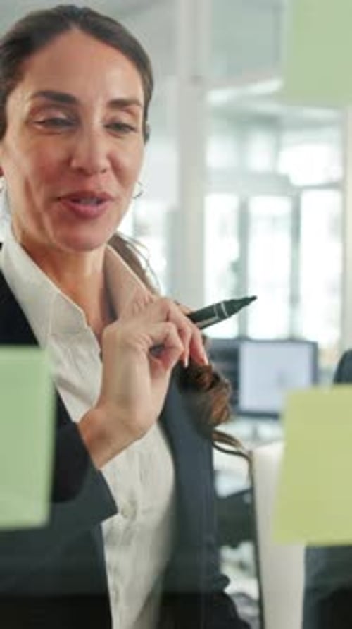 Meeting, planning and business woman by glass wall for discussion, finance strategy and agenda
