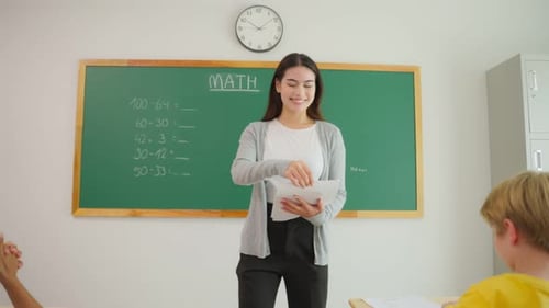 Group of student learn with teacher in classroom at elementary school.