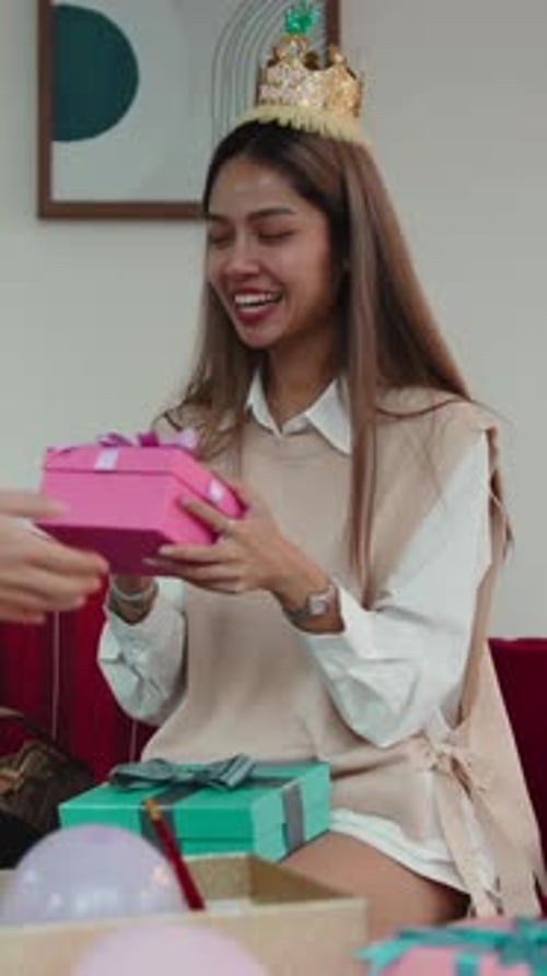 Smiling Young Woman Receives Birthday Presents