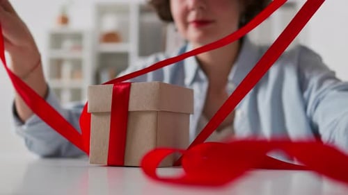 Close Up Female Hands Open A Gift. Opening A Gift Box By Female Hands, Festive Atmosphere Intriguing