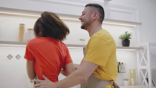 Loving Couple Celebrating in Kitchen Together