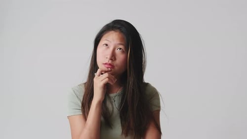 Young woman doubt and thinking with confusion isolated over white background in studio