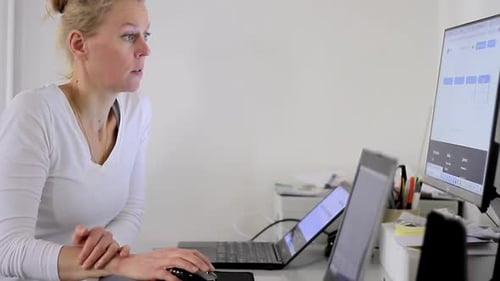 woman with credit card in office paying a bill typing on her laptop stock footage