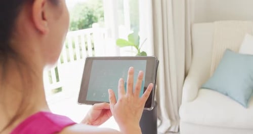 Woman Using Tablet for Home Automation Control