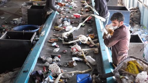 Cleaning Workers Sorting Garbage At Recycling Plant
