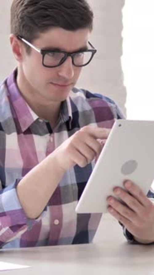 Young Man Using Tablet, Vertical Video