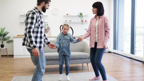 Happy Family Dancing Together at Home