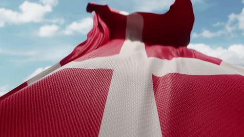 Realistic Denmark Flag Waving Against Blue Sky Loop