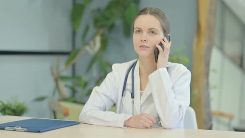 Female Doctor Talking on Phone in Clinic
