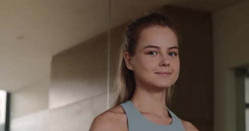 Portrait of a Fitness Girl in the Gym the Girl Looks at the Camera Smiling Positively Positive