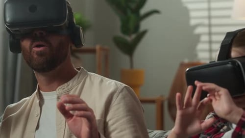 Family Uses Virtual Reality Headsets on Couch