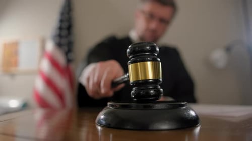 Judge with Gavel on Desk in Courtroom