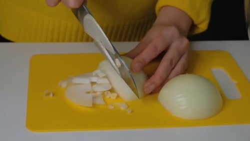 Slicing White Onion on a Yellow Cutting Board