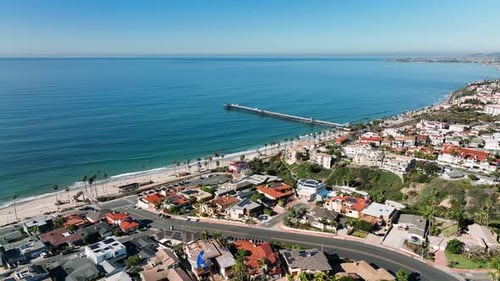 Aerial drone view of San Clemente Pier with beach and coastline before sunset time . San Clemente ci