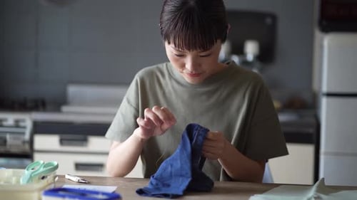 woman sewing children's clothes