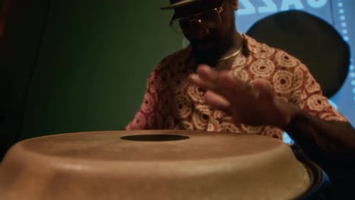 Hands of African American Drummer Playing Conga during Bar Performance