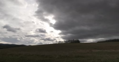 Storm clouds in a mountainous landscape.