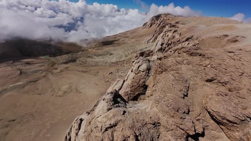 Mountain Range Aerial View Capturing Jagged Peaks Rising Through Misty Cloud Layers Exposing