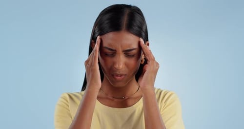 Stress, headache and Indian woman in studio with pain, inflammation and fatigue with anxiety