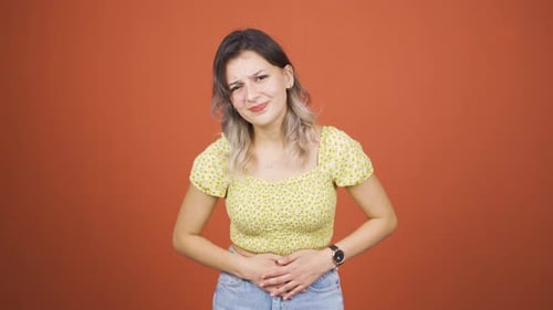 Young woman experiencing stomachache.