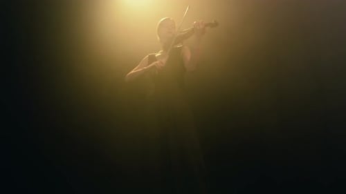 Woman Playing Violin in Spotlight