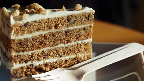 Enjoying Delicious Walnut Cake at a Cozy Cafe Setting