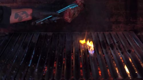 Barbecue Chef hit the grill with the steak and produce flame