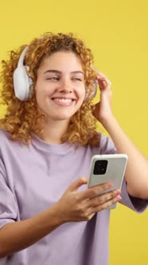 Happy Woman Listening to Music on Phone with Headphones
