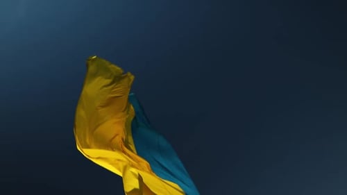 Ukrainian Flag Waving Against Dark Blue Sky