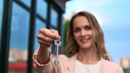 Smiling Blonde Woman Holding Keys Buying New Countryside House Real Estate Ownership and Mortgage