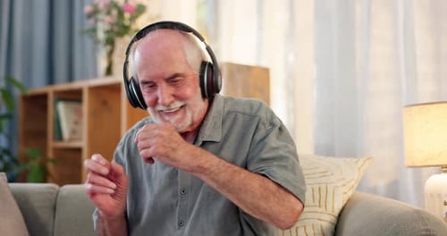 Senior Man Dancing at Home with Headphones