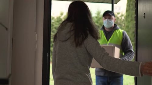 Woman Receives Home Delivery from Man Wearing Mask