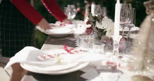 Christmas, hands and woman setting table for party, event and celebration gathering at home garden