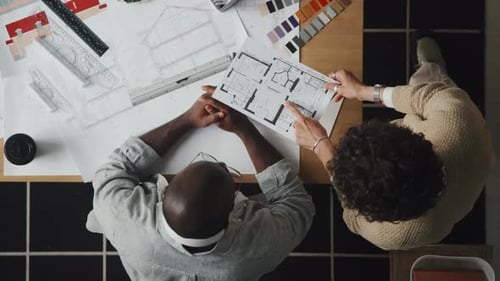 Architects Working on Blueprints in Office