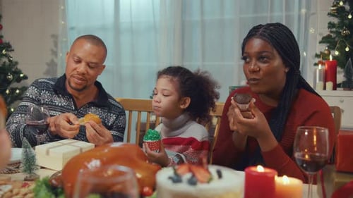 Family Enjoys Cupcakes at Christmas Dinner