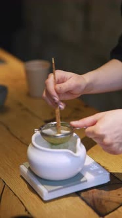 Matcha Process of Making Green Tea in a Bowl on Wooden Table Background