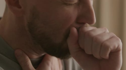 Close Up of Man Coughing and Sneezing during Illness at Home