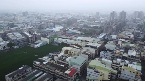Overcast cityscape with dense buildings, aerial view of an urban area on a cloudy day