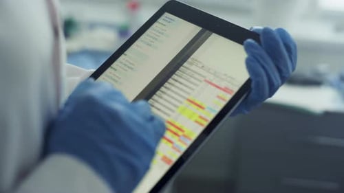 Doctor hands magnifying health history data on tablet in clinic office