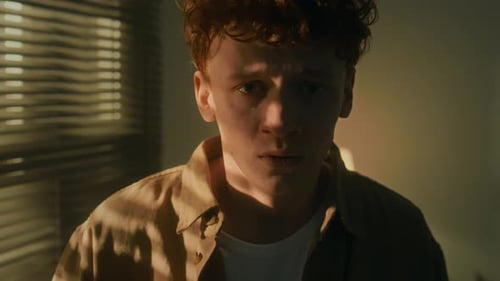 Sad Young Man Tears Welling Indoors at Night