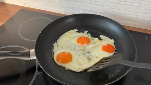 Frying eggs in a pan on the stove