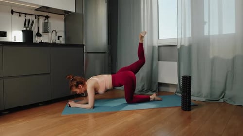 Healthy Woman Doing Yoga Exercise at the Kitchen