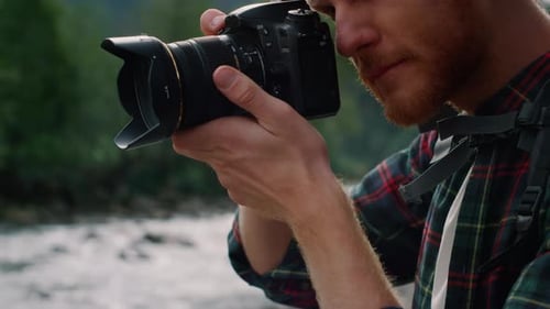 Man taking picture of nature with camera, outdoor